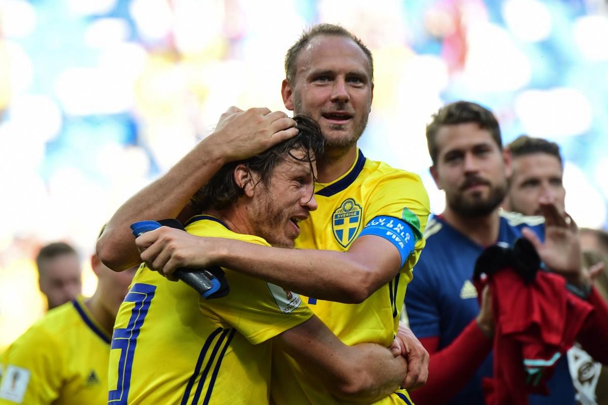 Sweden's midfielder Gustav Svensson (L) and Sweden's defender Andreas Granqvist embrace following their victory during the Russia 2018 World Cup Group F football match between Sweden and South Korea at the Nizhny Novgorod Stadium in Nizhny Novgorod on Monday (AFP Photo)