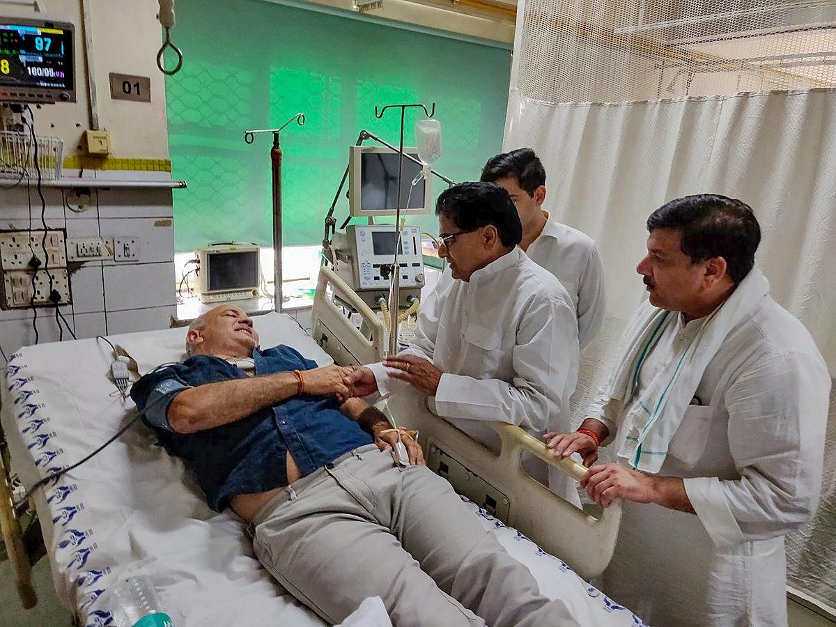 Samajwadi Party leader Ram Gopal Yadav along with AAP MP Sanjay Singh visits Deputy Chief Minister Manish Sisodia who is hospitalized at LNJP Hospital in New Delhi on Monday, June 18, 2018. Sisodia was on a hunger strike at Lt Governor's residence. (@AamAadmiParty via PTI Photo)