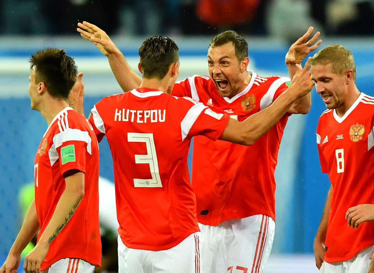 Russia's Artem Dzyuba celebrates scoring their third goal with team mates. REUTERS