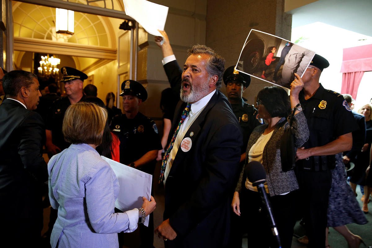 Rep. Juan Vargas (D-CA) and other Democratic members of Congress protest family separations at the US-Mexico border as US President Donald Trump departs after addressing a closed House Republican Conference meeting on Capitol Hill, in Washington. (REUTERS/Joshua Roberts)