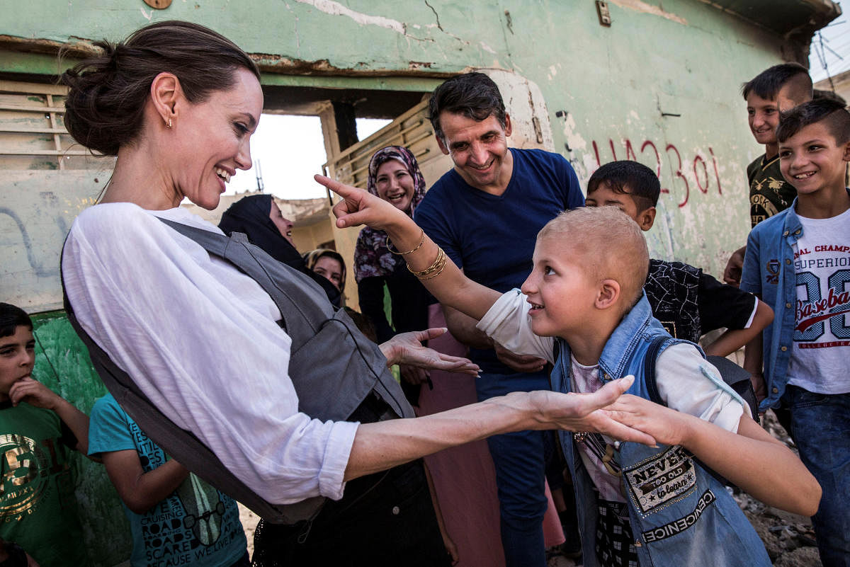 UNHCR Special Envoy Angelina Jolie meets Falak, 8, during a visit to West Mosul, Iraq June 16, 2018. UNHCR/Andrew McConnell/Handout via REUTERS
