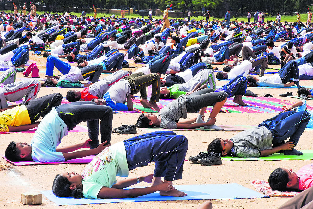 NCC cadets practise yoga at the Manekshaw Parade Ground on Wednesday. DH Photo/S K Dinesh