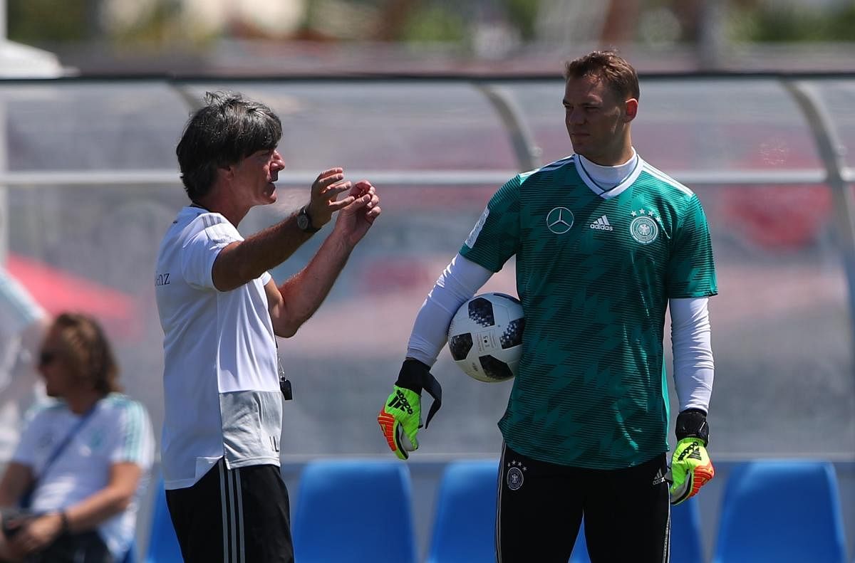 LET'S TRY THIS... Germany's coach Joachim Loew has a chat with goalkeeper Manuel Neuer during a training session. REUTERS