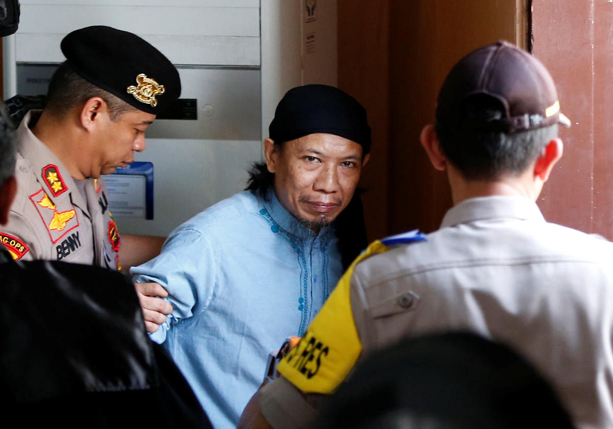 Islamic cleric Aman Abdurrahman leaves a court following his verdict in Jakarta, Indonesia, June 22, 2018. REUTERS