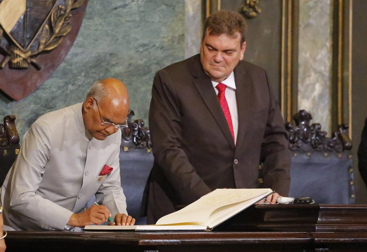 India's President Ram Nath Kovind signs the visitors' book Havana University President Gustavo Cobreiro Suarez watches, in Havana, Cuba, Friday, June 22, 2018. Kovind is on a two-day official visit to Cuba. (AP/PTI photo)