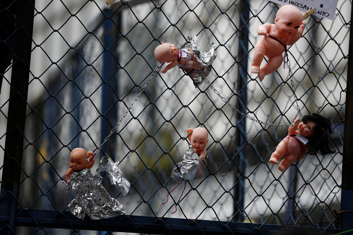 Dolls are seen tied to a fence during a protest against US immigration policies outside the US embassy in Mexico City. (Reuters file pic)
