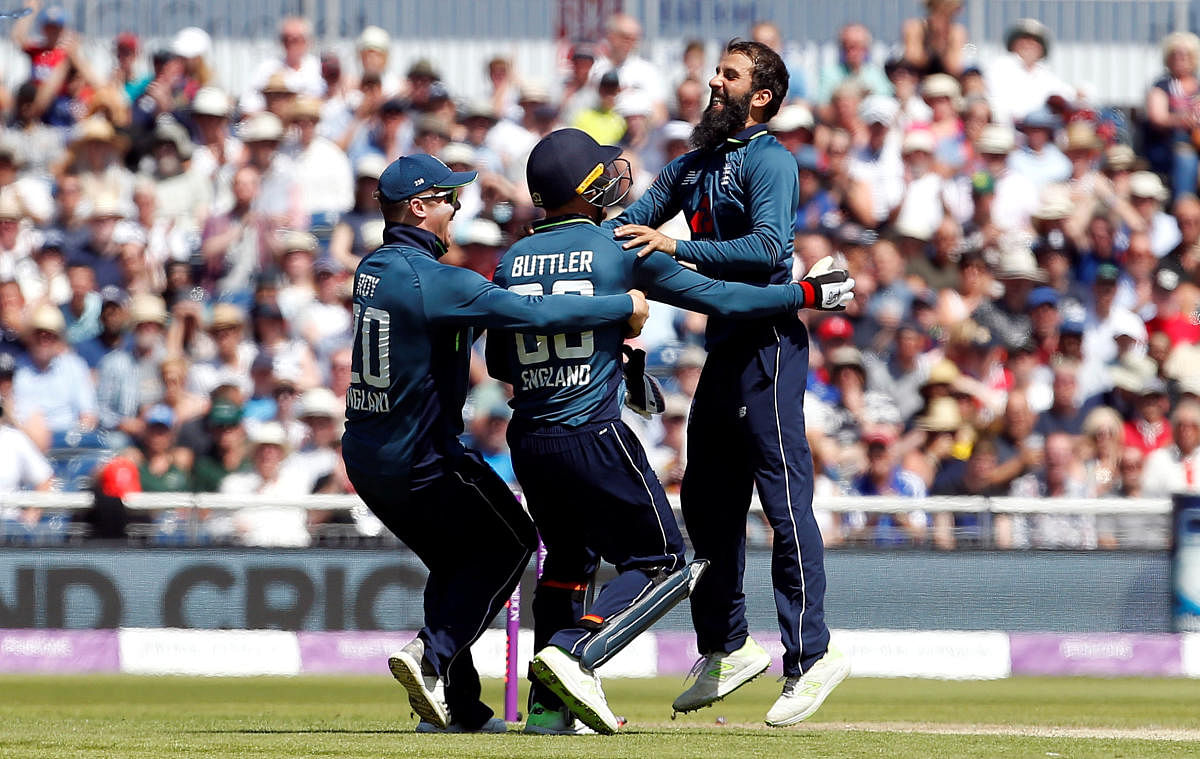 England's Moeen Ali (right) celebrates with team-mates after dismissing Australia's Tim Paine in the fifth and final ODI in Manchester on Sunday. Reuters