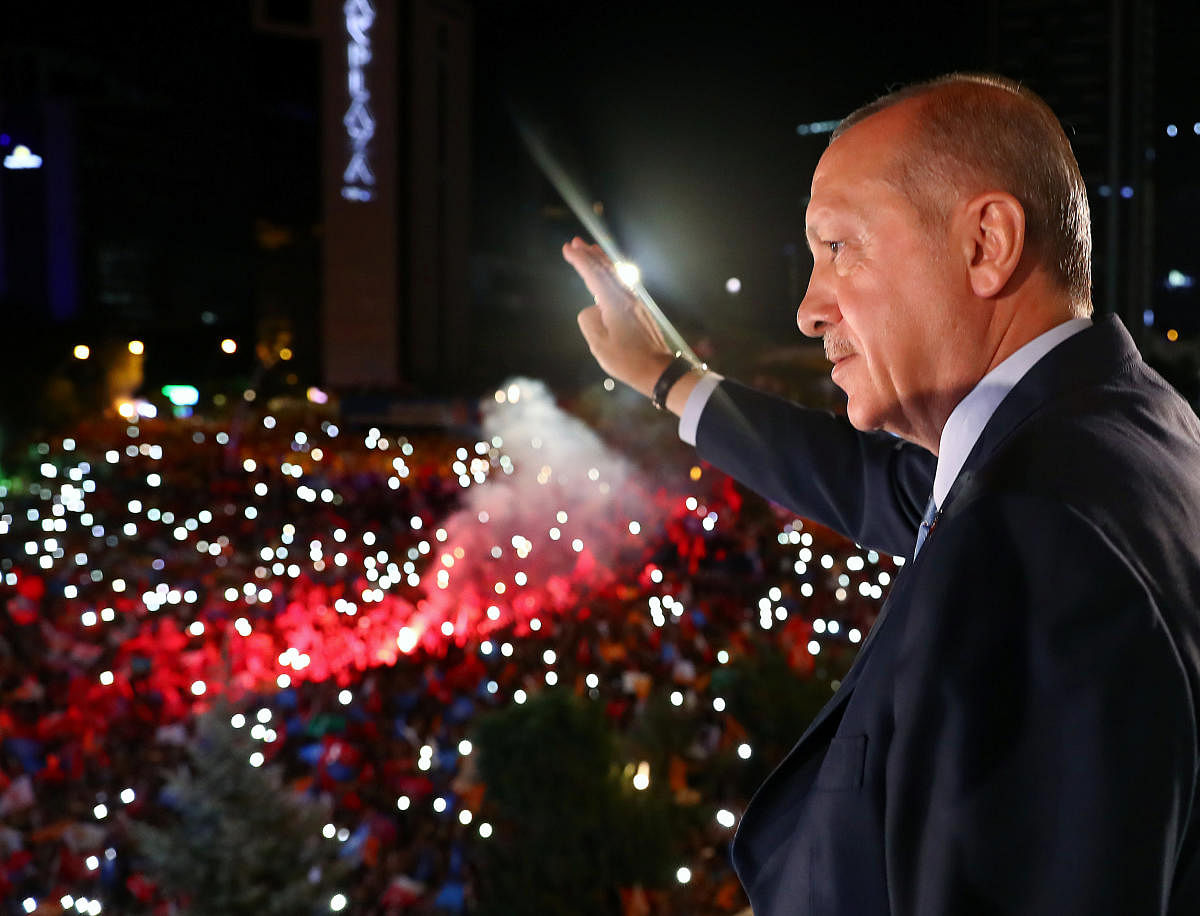 Turkish President Tayyip Erdogan greets his supporters from the balcony of his ruling AK Party headquarters in Ankara, Turkey. (Reuters Photo)