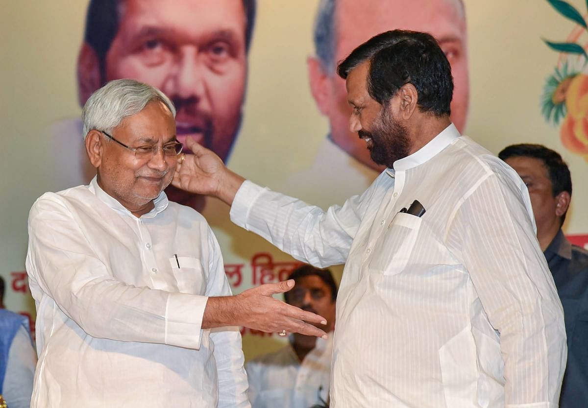 Bihar Chief Minister Nitish Kumar (left) with Lok Janshakti Party chief Ram Vilas Paswan during the birth anniversary of former prime minister V P Singh, in Patna on Monday. PTI