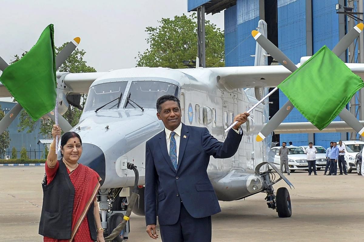External Affairs Minister Sushma Swaraj and Seychelles President Danny Faure wave flags during the handing over ceremony of Dornier aircraft to Seychelles, at Palam Technical Area, in New Delhi on Tuesday. PTI