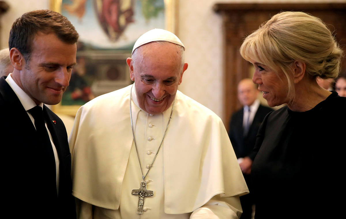 Pope Francis shares a word with French President Emmanuel Macron and his wife Brigitte during a private audience at the Vatican on June 26, 2018. Reuters