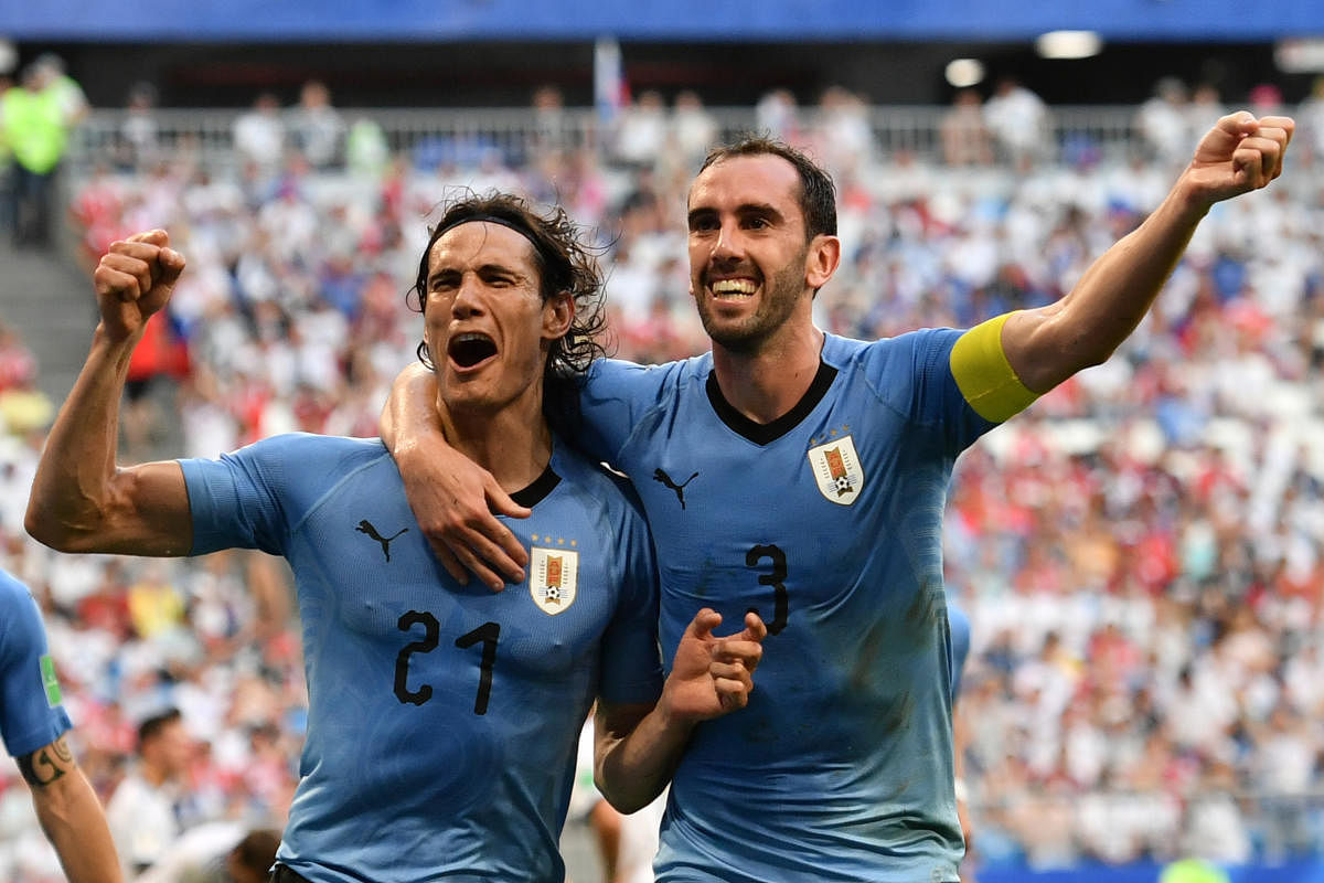 Uruguay's forward Edinson Cavani celebrates with Diego Godin (R) after scoring a goal during the Russia 2018 World Cup Group A football match between Uruguay and Russia at the Samara Arena in Samara. AFP