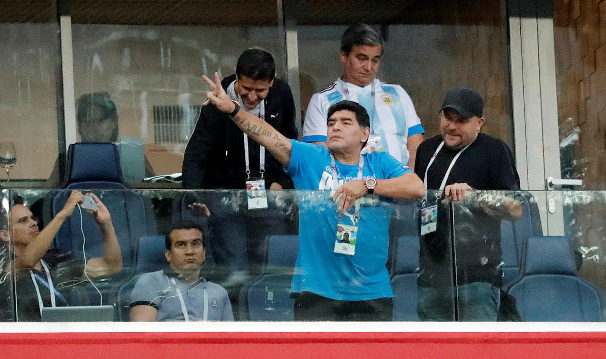 Diego Maradona gestures to the fans from the stands during the match. (REUTERS photo)