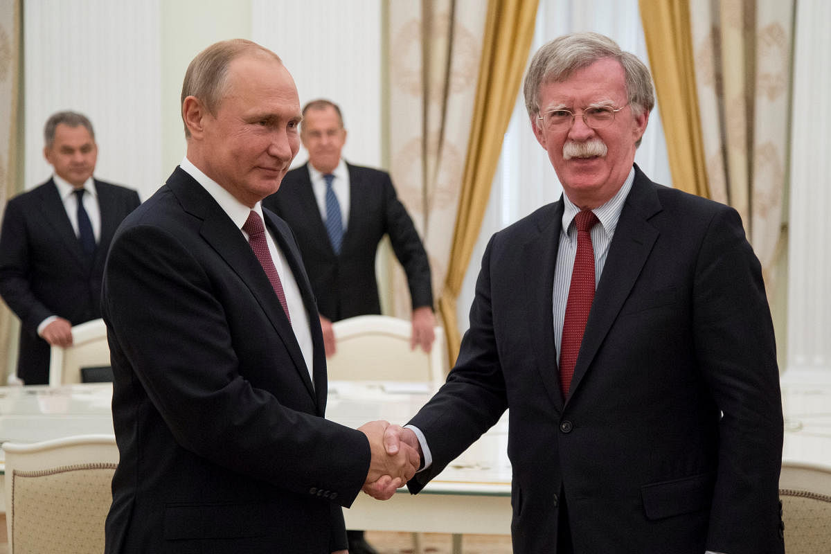 Russia's President Vladimir Putin shakes hands with US National Security Adviser John Bolton during a meeting at the Kremlin in Moscow, Russia June 27, 2018. Reuters