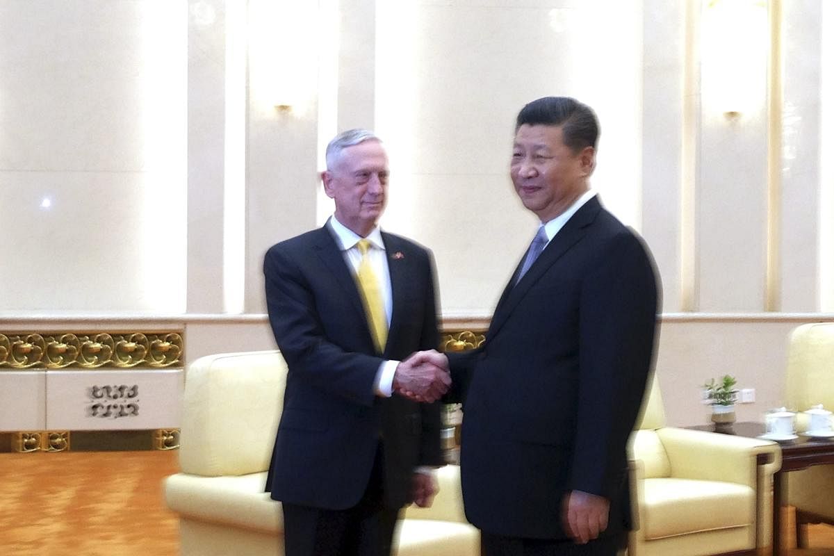U.S. Defense Secretary Jim Mattis, left, shakes hands with Chinese President Xi Jinping as they pose for photographers before a meeting at the Great Hall of the People in Beijing. (AP/PTI Photo)