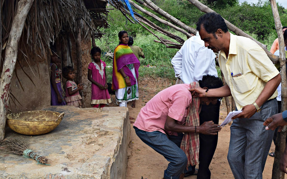 The survivor, Madappa, thanks one of the rescuers.