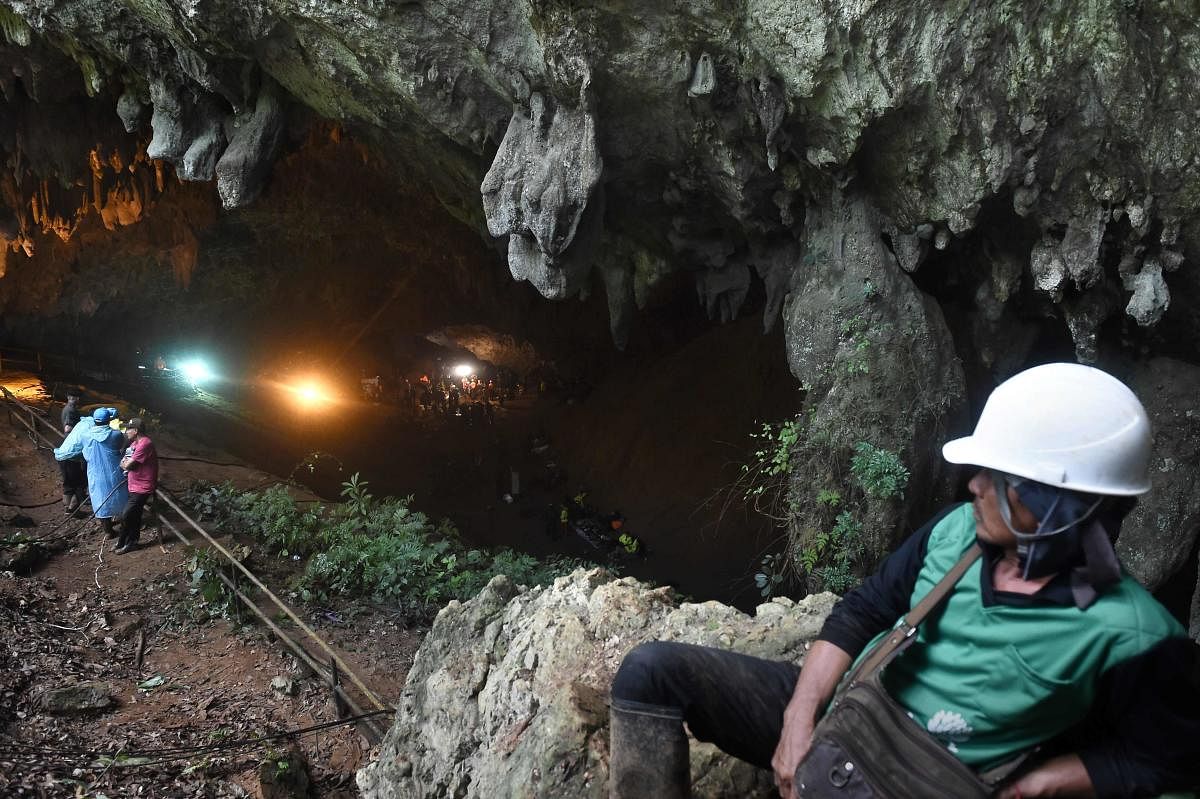 Rescue personnel are seen at the opening of the Tham Luang cave in Khun Nam Nang Non Forest Park, Thailand, during an operation to search for a missing children's football team and their coach. (AFP File Pic)