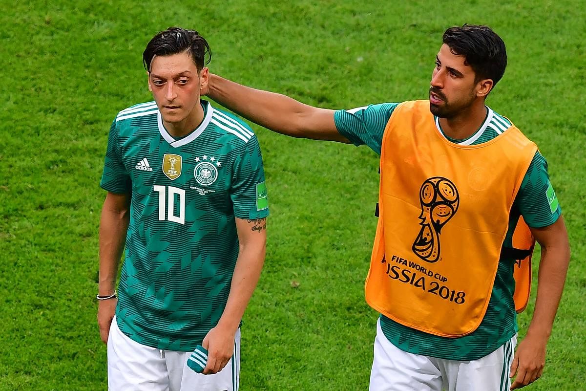 MULTIPLE PROBLEMS: Seasoned players like Mesut Ozil (left) and Sami Khedira failed to hit their high standards of old that contributed immensely to Germany's downfall at this World Cup. AFP