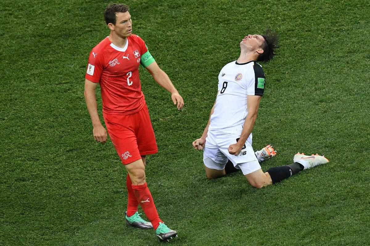 SITTING OUT: Switzerland's captain Stephan Lichtsteiner (left) will miss his team's last-16 game against Sweden. AFP 