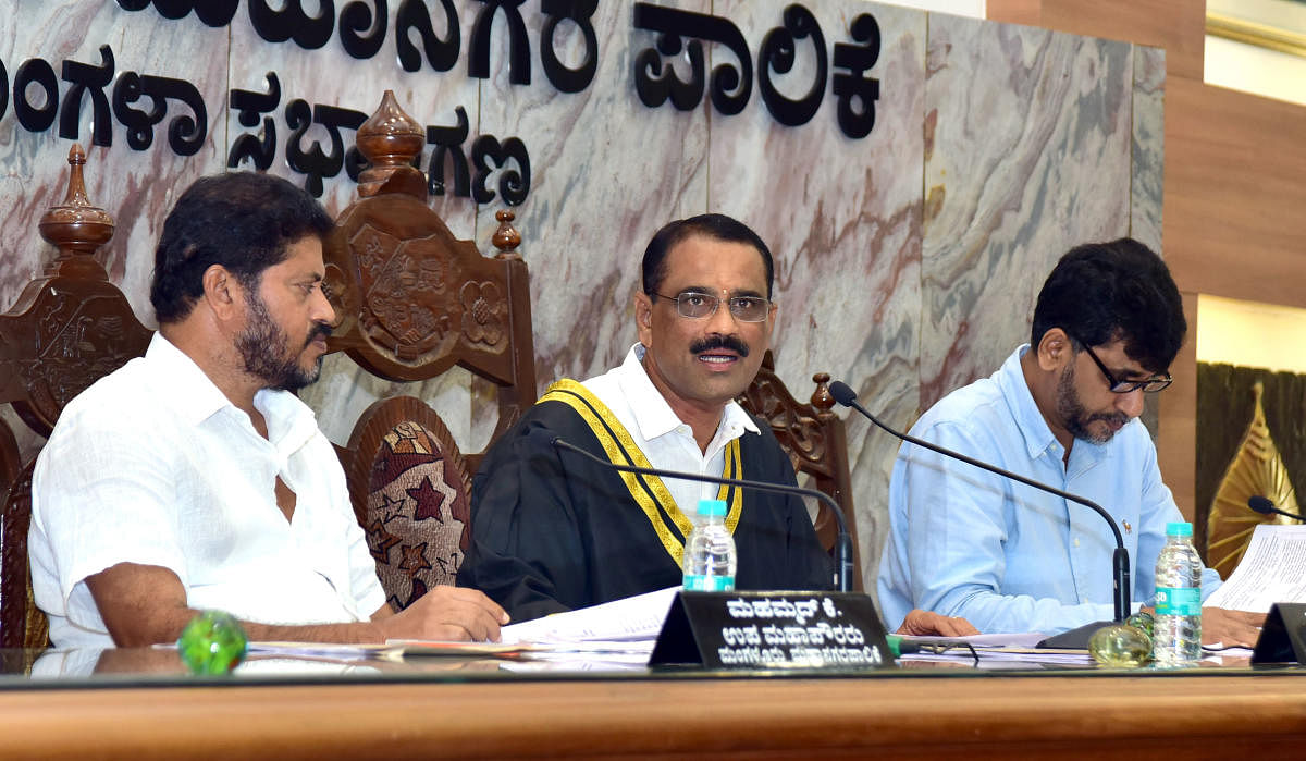 Mayor Bhaskar K chairs the Mangaluru City Corporation meeting on Thursday. Deputy Mayor Muhammed K and Commissioner B A Muhammed Nazir look on.