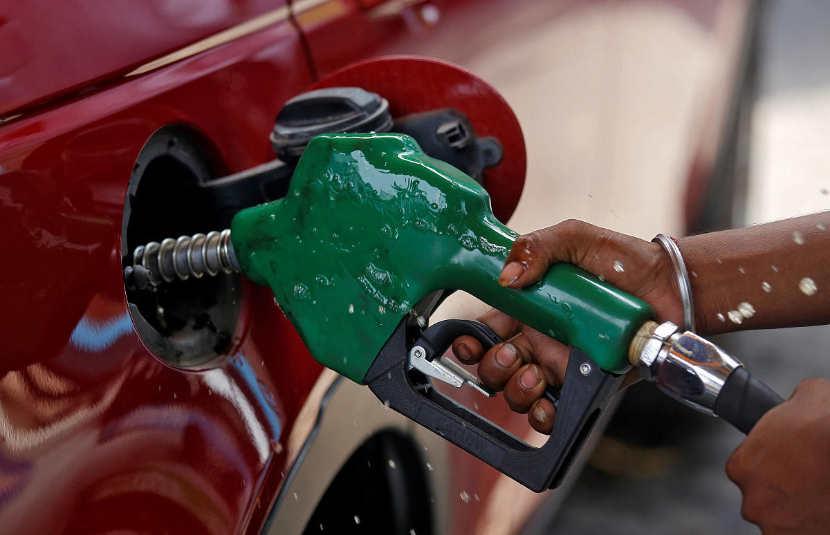 A worker holds a nozzle to pump petrol into a vehicle at a fuel station in Mumbai. (Reuters pic for representation only)