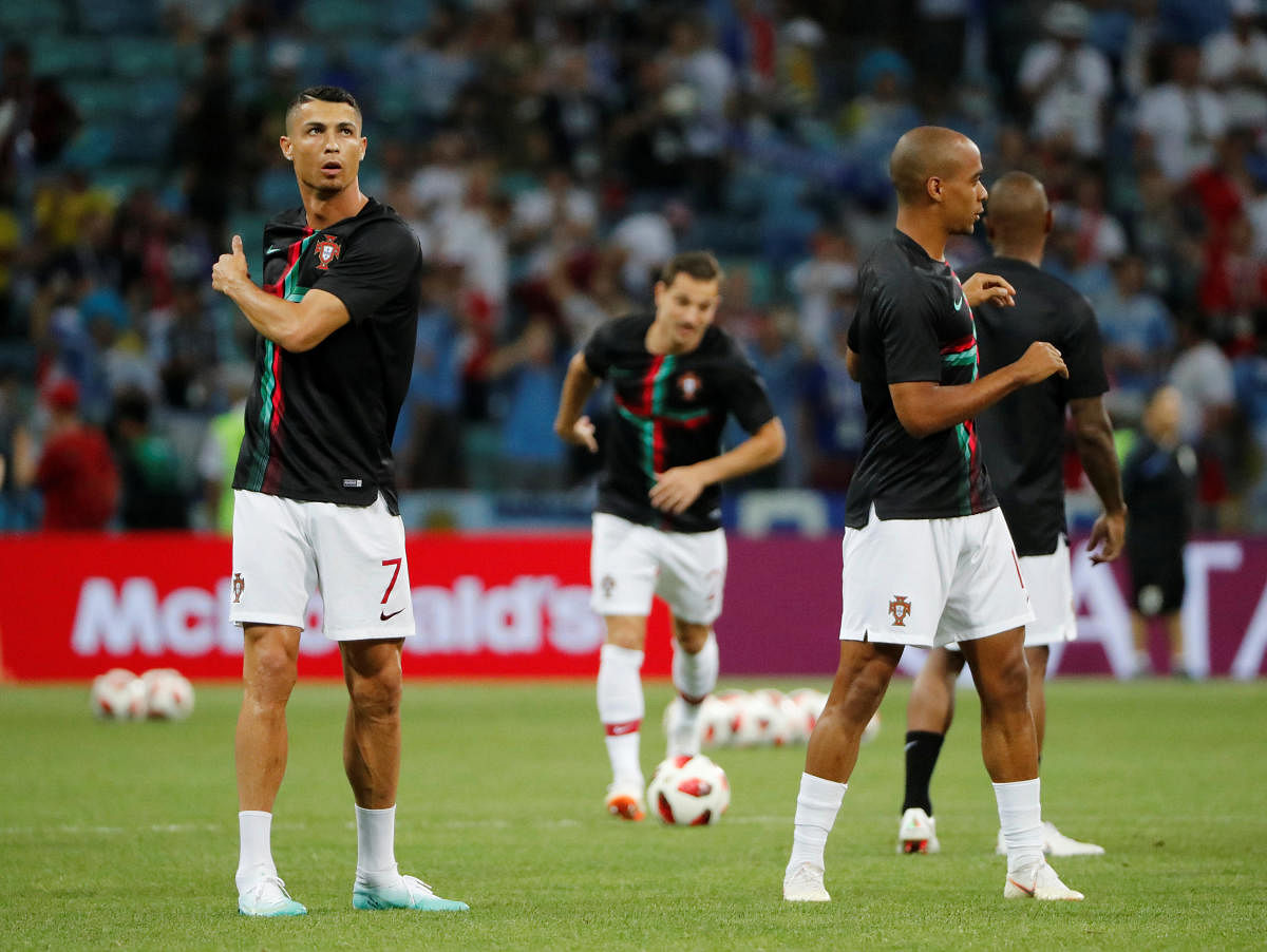 Portugal's Cristiano Ronaldo and Joao Mario during the warm up before the match REUTERS