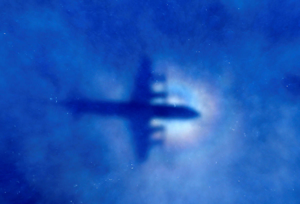FILE PHOTO: The shadow of a Royal New Zealand Air Force (RNZAF) P3 Orion maritime search aircraft can be seen on low-level clouds as it flies over the southern Indian Ocean looking for missing Malaysian Airlines flight MH370 March 31, 2014. REUTERS