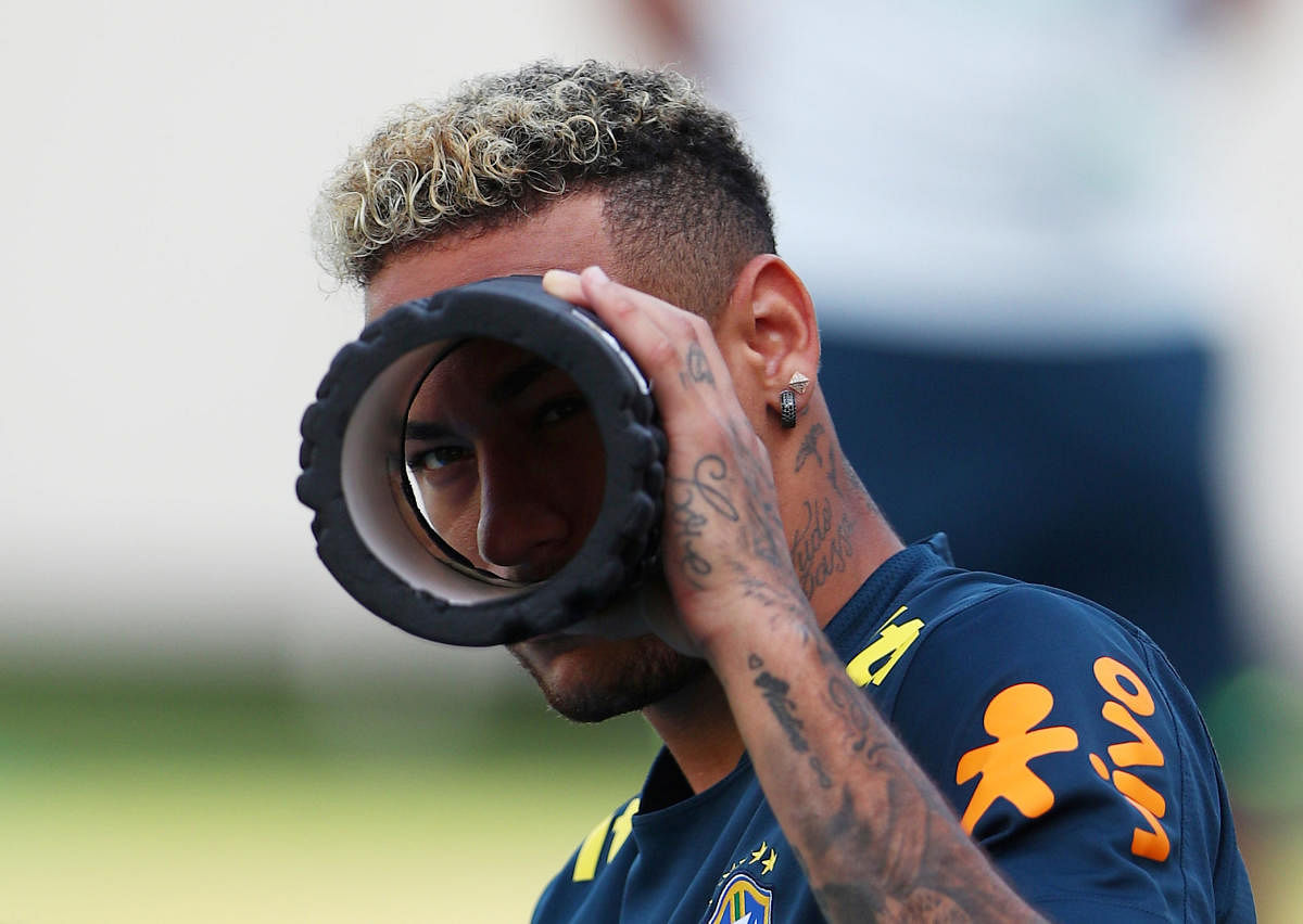 SEEKING THE LARGER PICTURE: Brazil superstar Neymar in a playful mood during a practice session ahead of the mouth-watering clash against Mexico. REUTERS