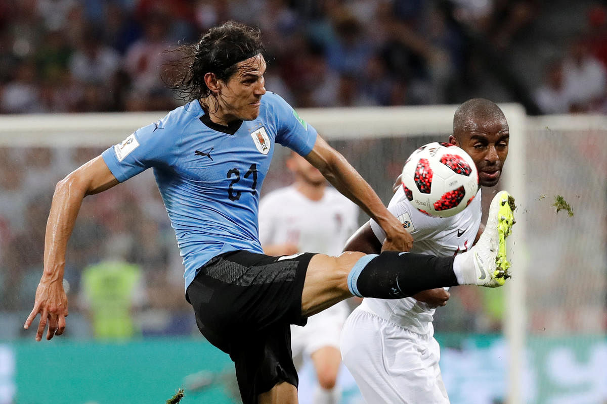 Uruguay's Edinson Cavani in action with Portugal's Ricardo Pereira. REUTERS.
