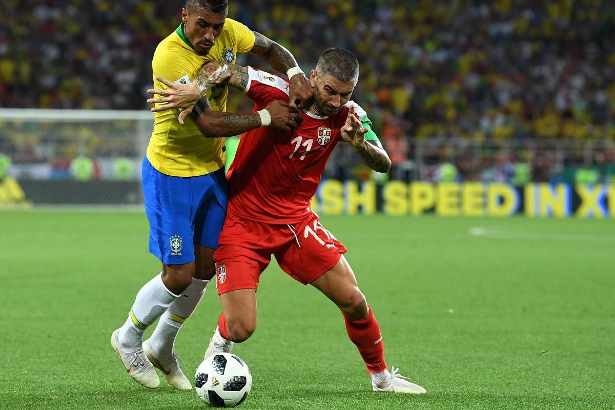Brazil's midfielder Paulinho (L) fights for the ball with Serbia's defender Aleksandar Kolarov during the Russia 2018 World Cup Group E football match between Serbia and Brazil at the Spartak Stadium in Moscow. AFP Photo