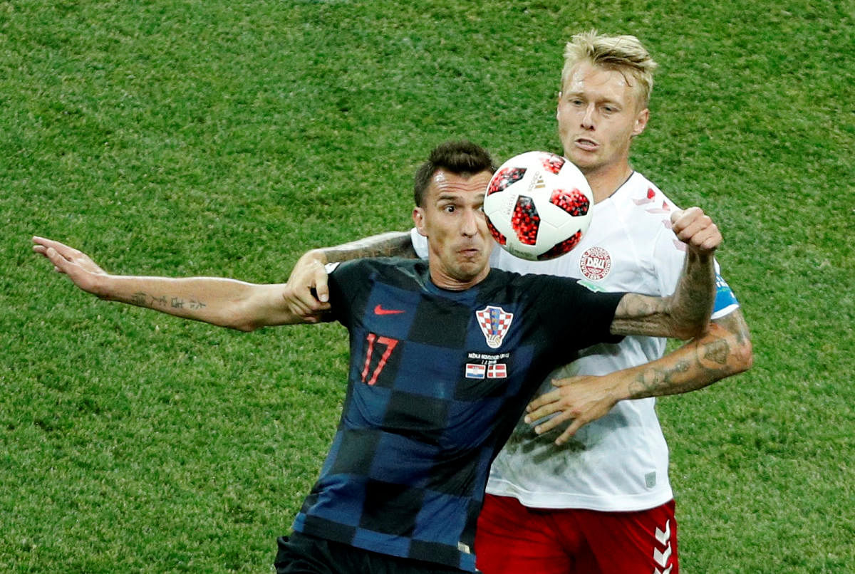 Croatia's Mario Mandzukic in action with Denmark's Simon Kjaer REUTERS