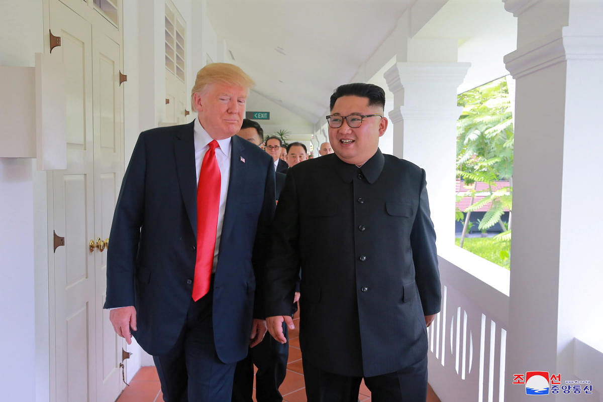 US President Donald Trump walks with North Korean leader Kim Jong Un at the Capella Hotel on Sentosa island in Singapore. REUTERS