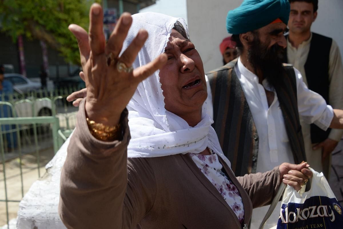 An Afghan Sikh woman weeps during a burial ceremony following a suicide attack in Jalalabad on Monday, a day after the attack. (AFP Photo)