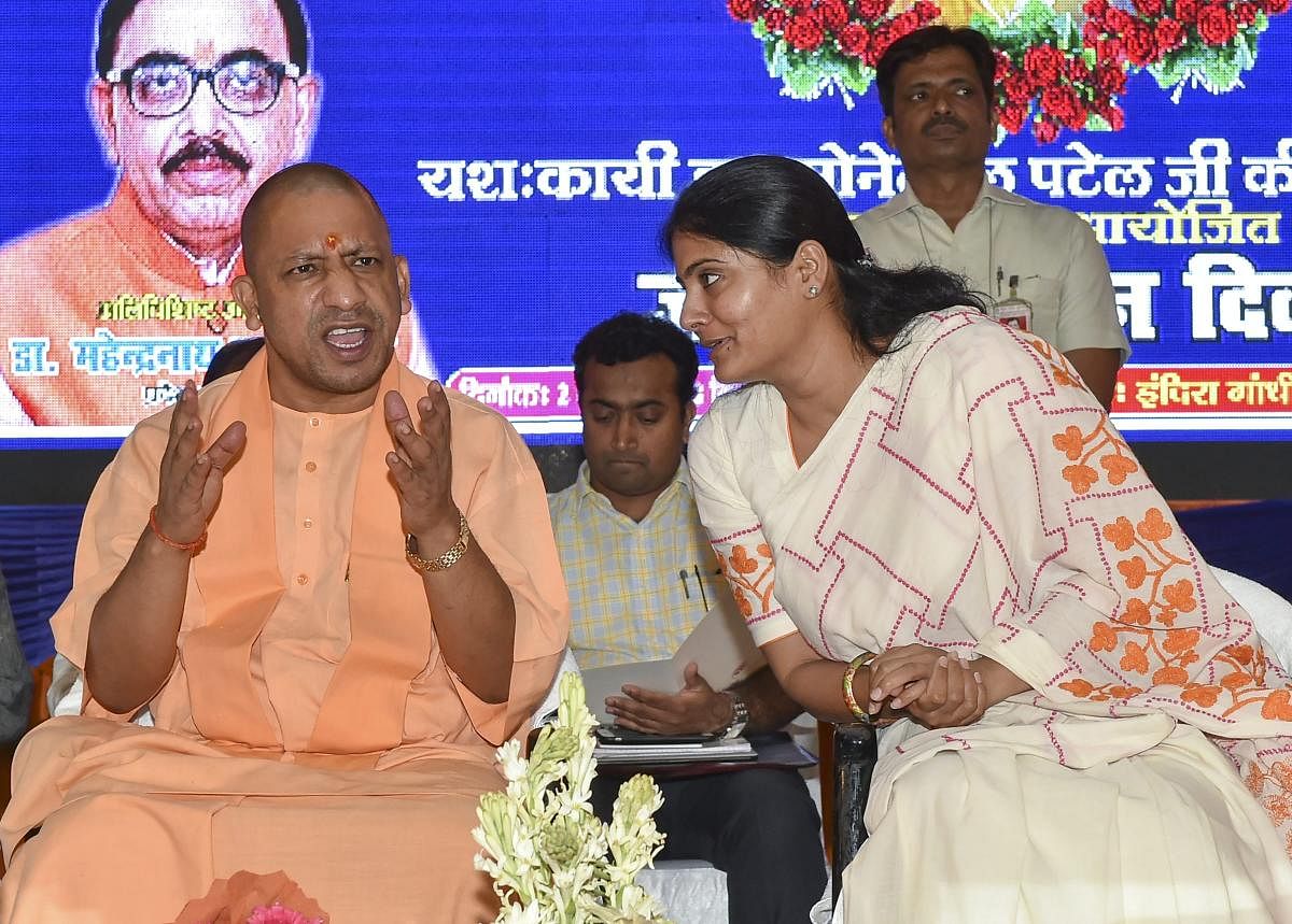 Uttar Pradesh Chief Minister Yogi Adityanath exchanges greetings with Union minister and Apna Dal leader Anupriya Patel at a function to celebrate her father Sonelal Patel's 69th birth anniversary, in Lucknow on Monday, July 2, 2018. PTI Photo