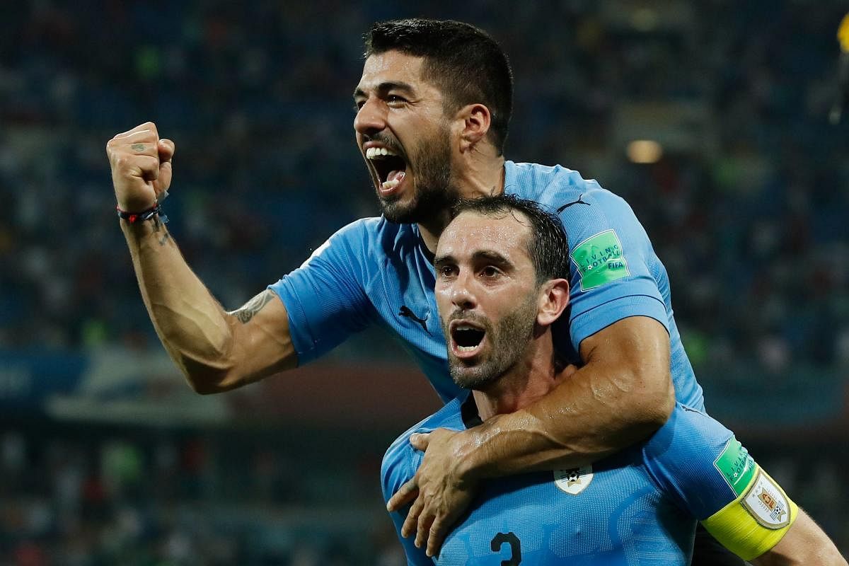 HERE WE COME! A combination of deadly strikers like Luis Suarez (back) and robust defenders like Diego Godin has turned Uruguay into a strong force. AFP