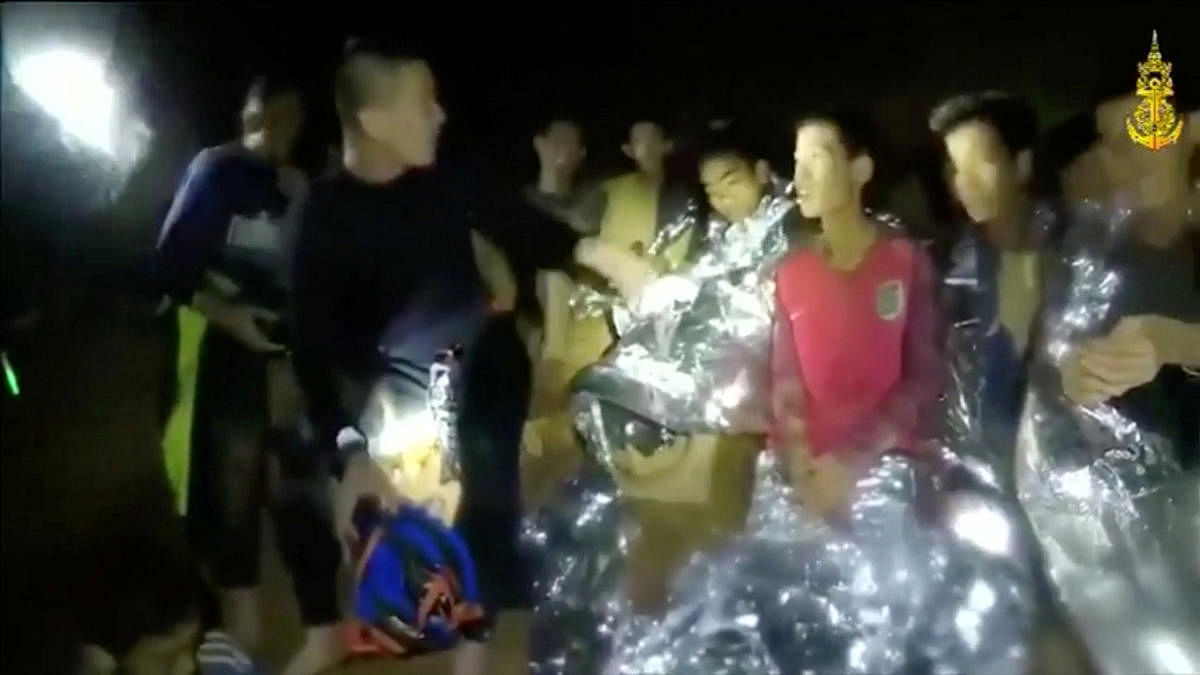 Boys from the under-16 soccer team trapped inside Tham Luang cave greet members of the Thai rescue team in Chiang Rai, Thailand, in this still image taken from a July 3, 2018 video by Thai Navy Seal. Thai Navy Seal/Handout via REUTERS