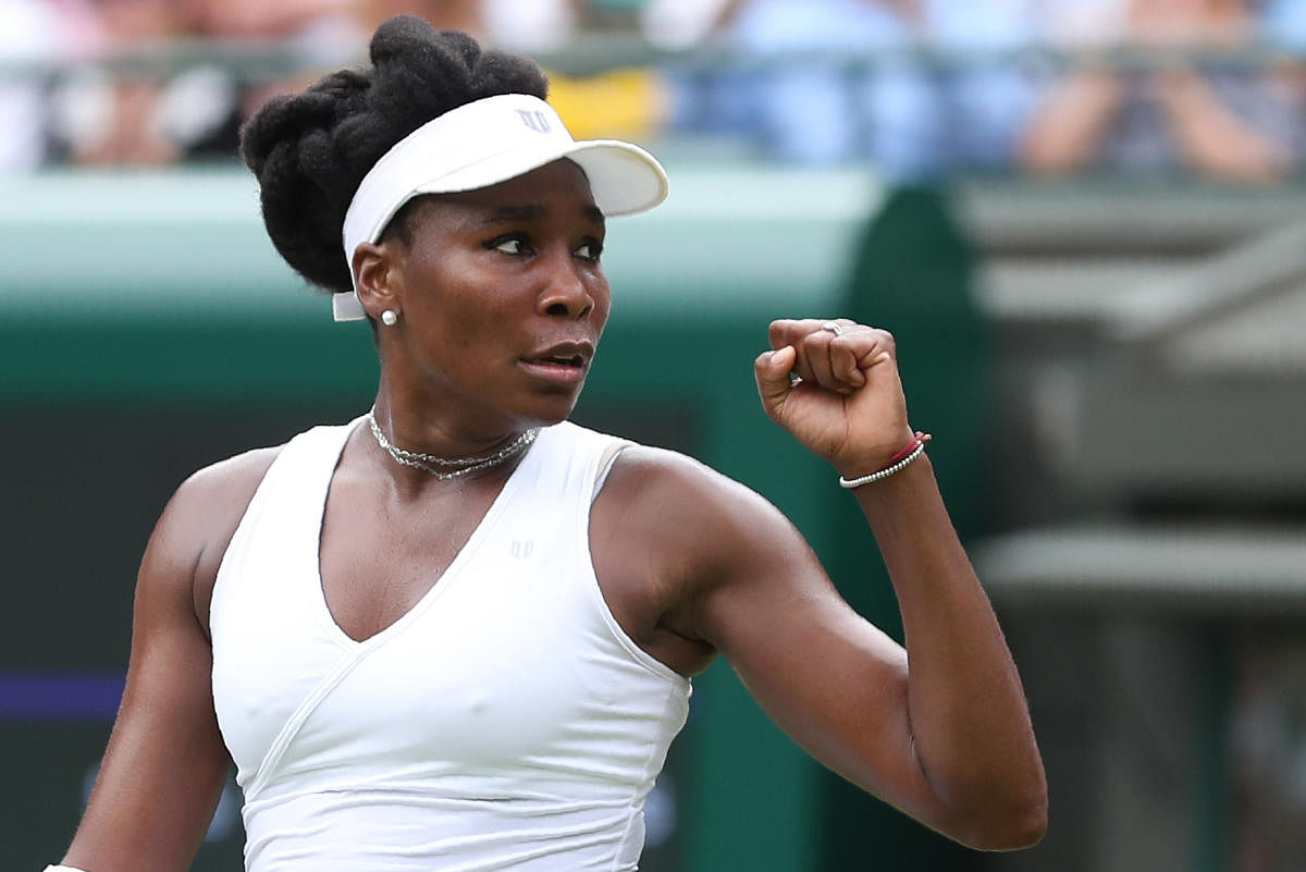 US player Venus Williams celebrates after beating Romania's Alexandra Dulgheru 4-6, 6-0, 6-1 in their women's singles second round match on the third day of the 2018 Wimbledon Championships at The All England Lawn Tennis Club in Wimbledon, southwest Londo