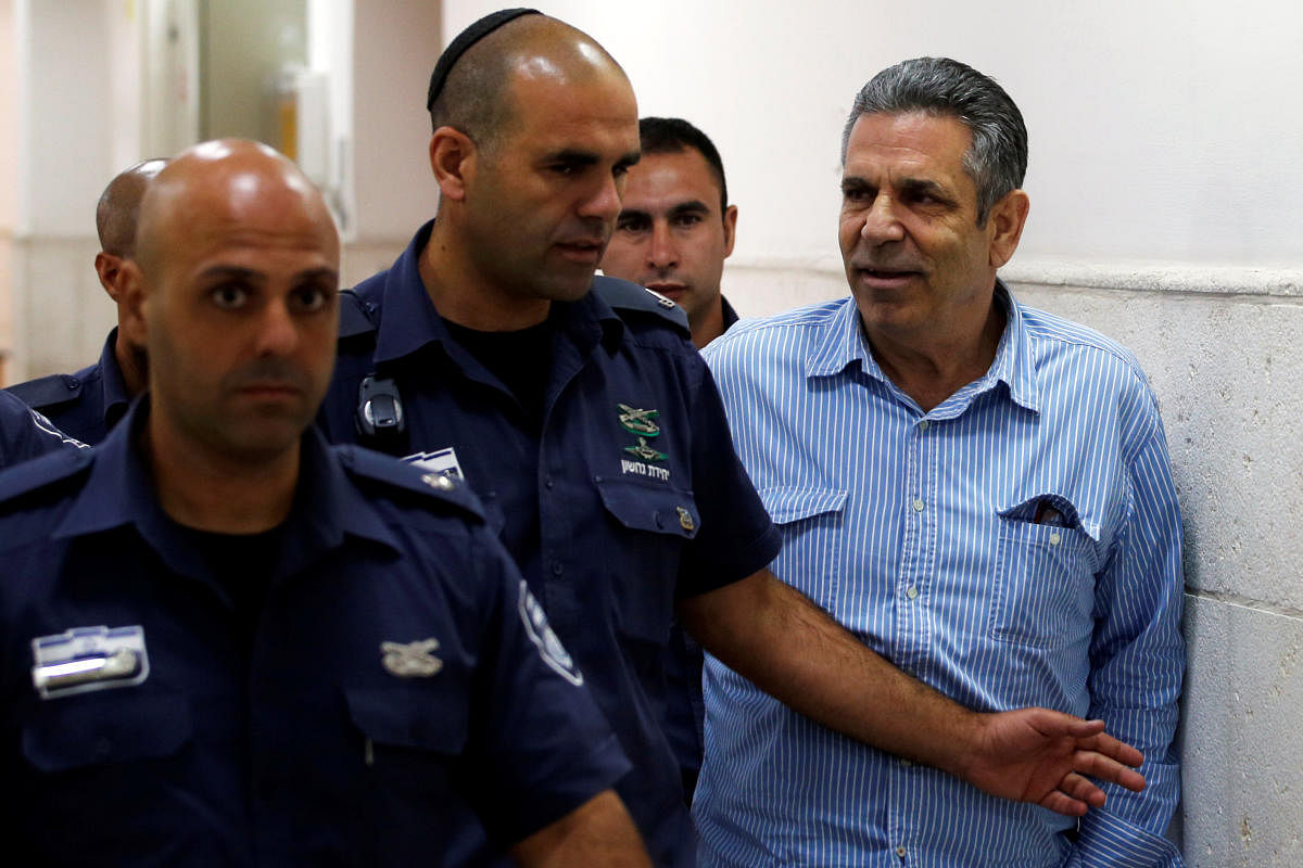 Gonen Segev, a former Israeli cabinet minister indicted on suspicion of spying for Iran, is escorted by prison guards as he arrives at court in Jerusalem. REUTERS Photo