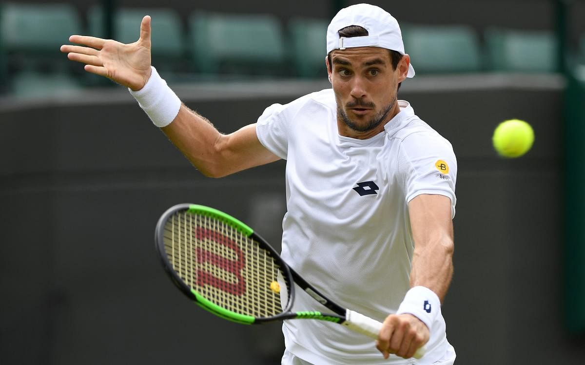 Argentina's Guido Pella returns to Croatia's Marin Cilic during their men's singles second round match at The All England Lawn Tennis Club on Thursday. AFP