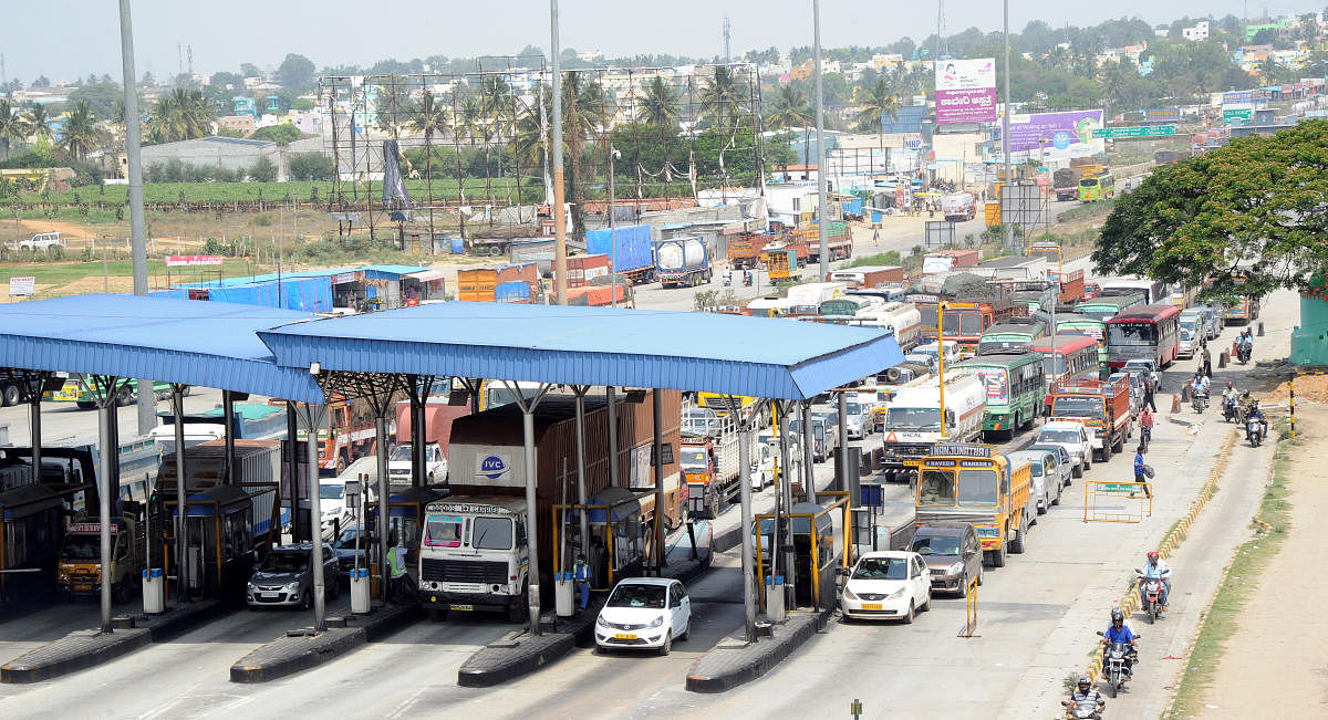 Vehicles in a long queue at the Attibele toll plaza on Hosur road near Bengaluru. (DH File Photo/Srikanta Sharma R)