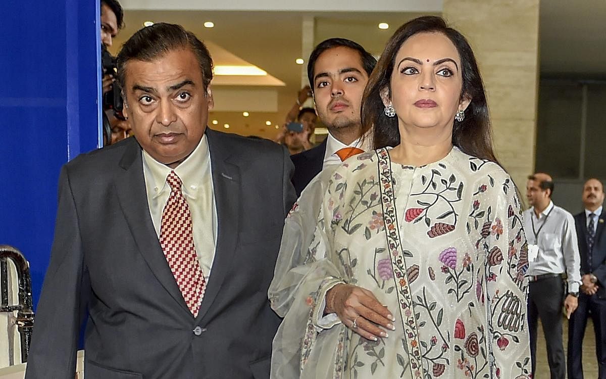 Reliance Industries Chairman Mukesh Ambani with wife Nita Ambani arrives for the 41st Annual General Meeting (AGM) of the company, in Mumbai on Thursday. (PTI Photo)