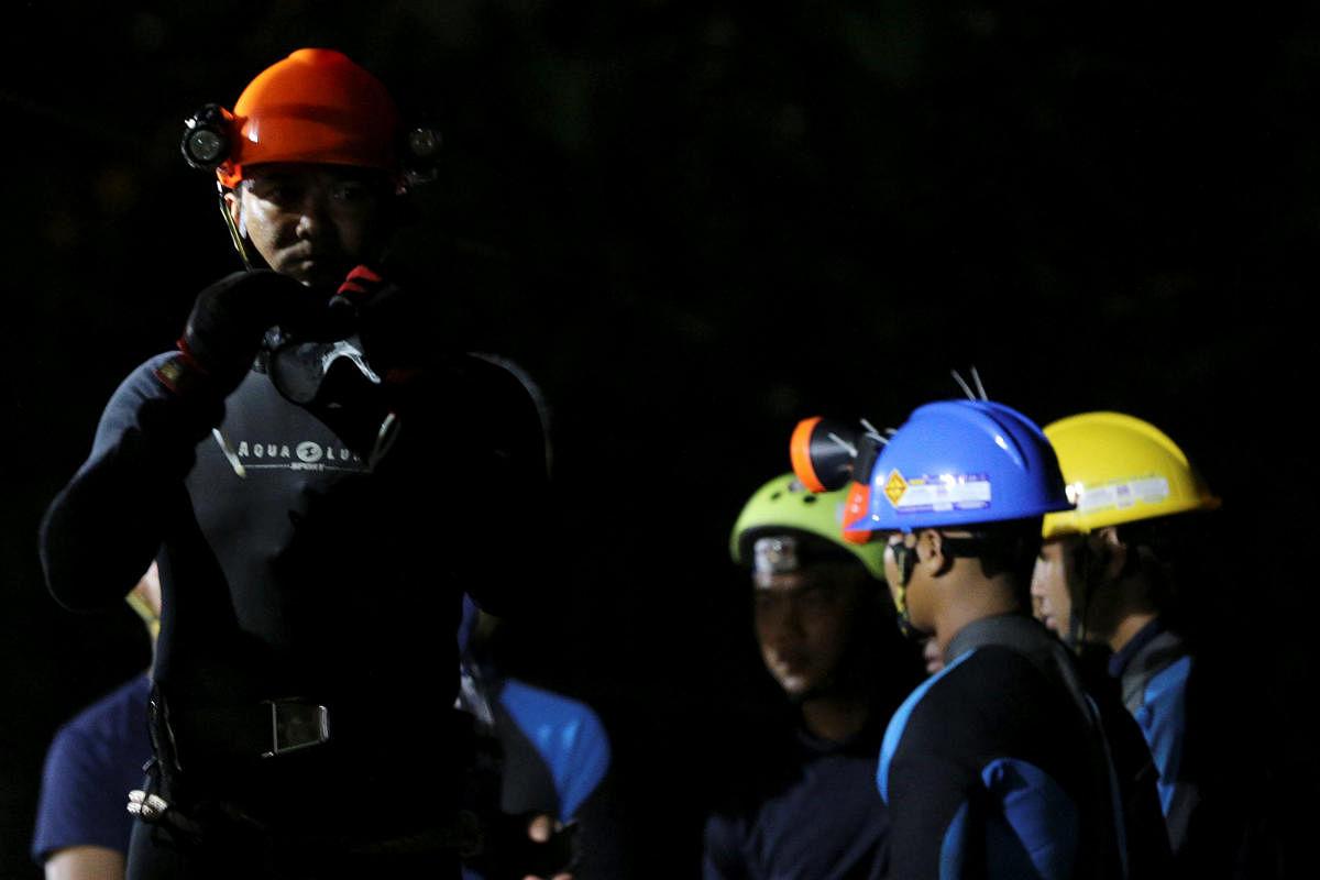 Thai divers gather before they enter to the Tham Luang cave, where 12 boys and their soccer coach are trapped, in the northern province of Chiang Rai, Thailand, July 6, 2018. REUTERS