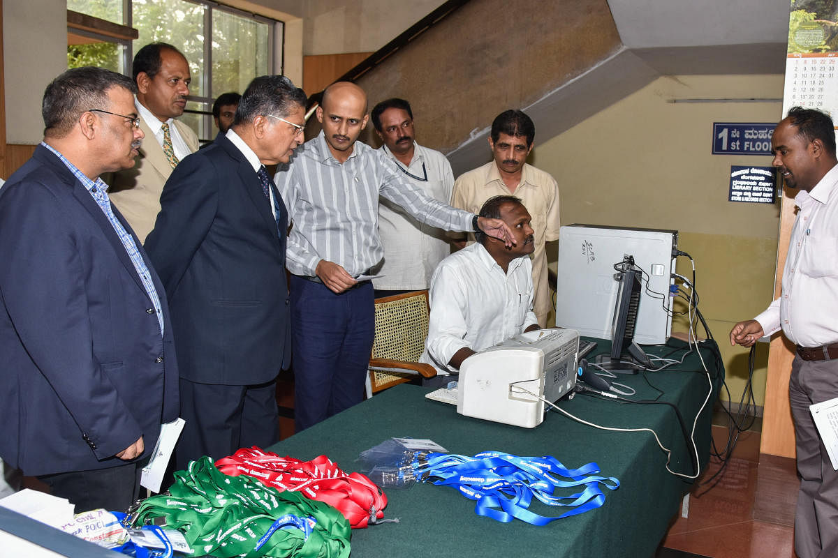 kicker: Pawan Nejjur, Superintendent of Police, explains the new security system for visitors, to Lokayukta Justice P Vishwanth Setty at the Lokayukta office in Bengaluru on Friday. Sanjay Sahay, ADGP, and others are seen. dh photo
