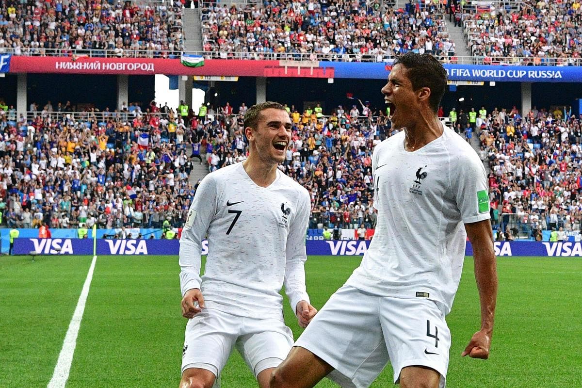 France's defender Raphael Varane (R) celebrates with Antoine Griezmann after scoring the opener during the Russia 2018 World Cup quarterfinal match against Uruguay at the Nizhny Novgorod Stadium in Russia on Friday. AFP