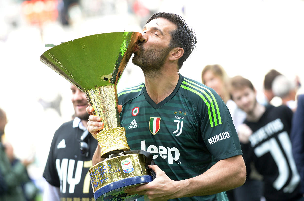 Juventus' Gianluigi Buffon celebrates winning the league by kissing the trophy. (Reuters File Photo)