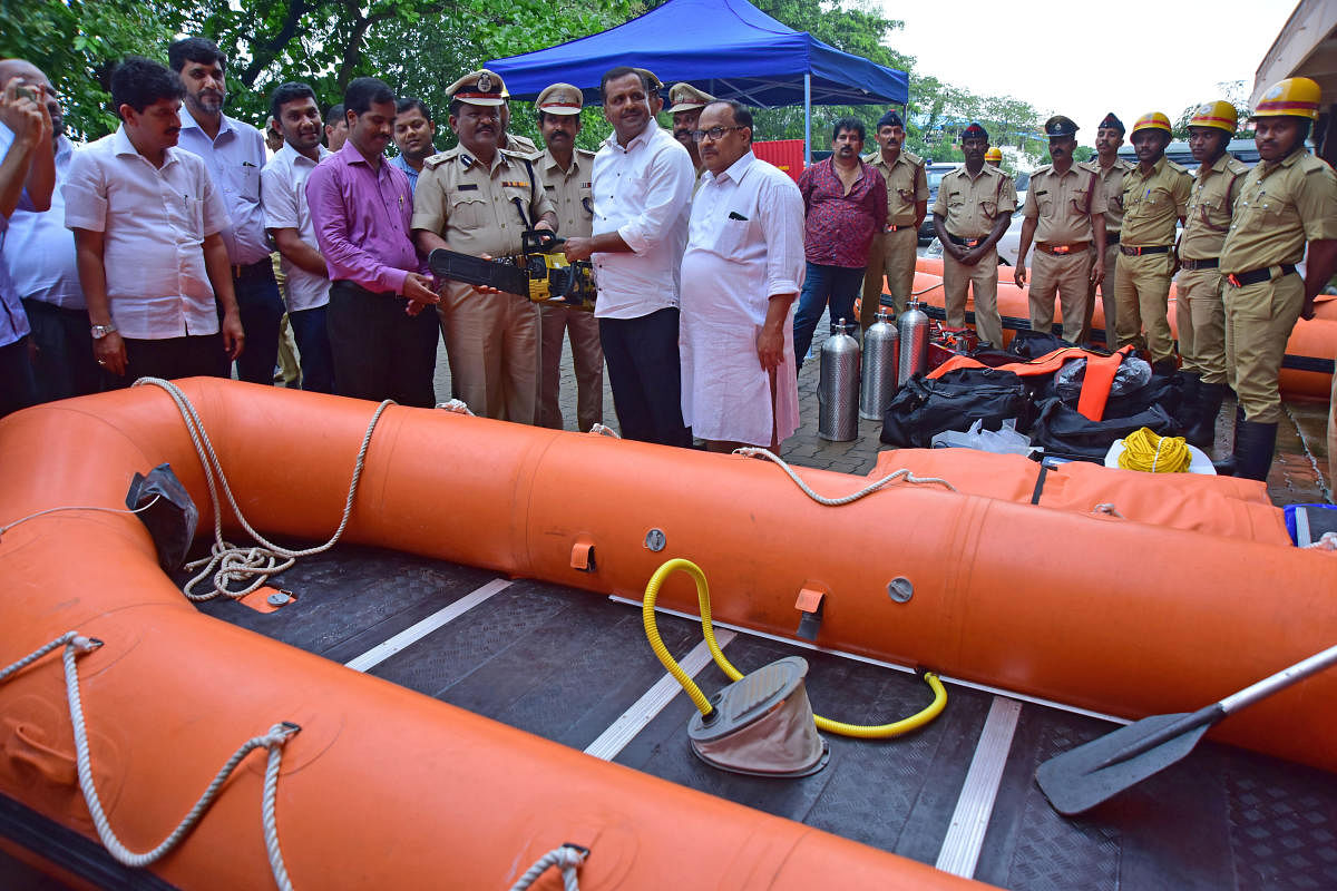 Minister for Urban Development and Housing U T Khader hands over equipment purchased by the district administration to fire service personnel in Mangaluru on Saturday.