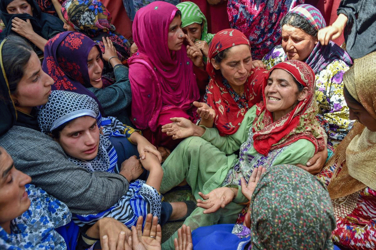 Village women console the relatives of three civilians (including a girl), who were allegedly killed in security forces action, during their funeral procession at Hawoorah Mishipora, in Kulgam district on Saturday, July 7, 2018. PTI Photo