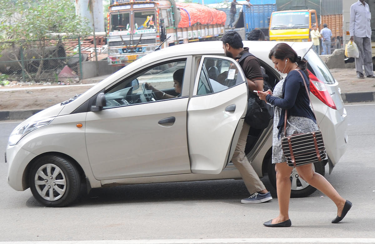 People taking cab infront of the Nayandanahalli Metro station due to the Namma Metro service was shout down from early morning to afternoon in Bengaluru on Friday. Photo Srikanta Sharma R.