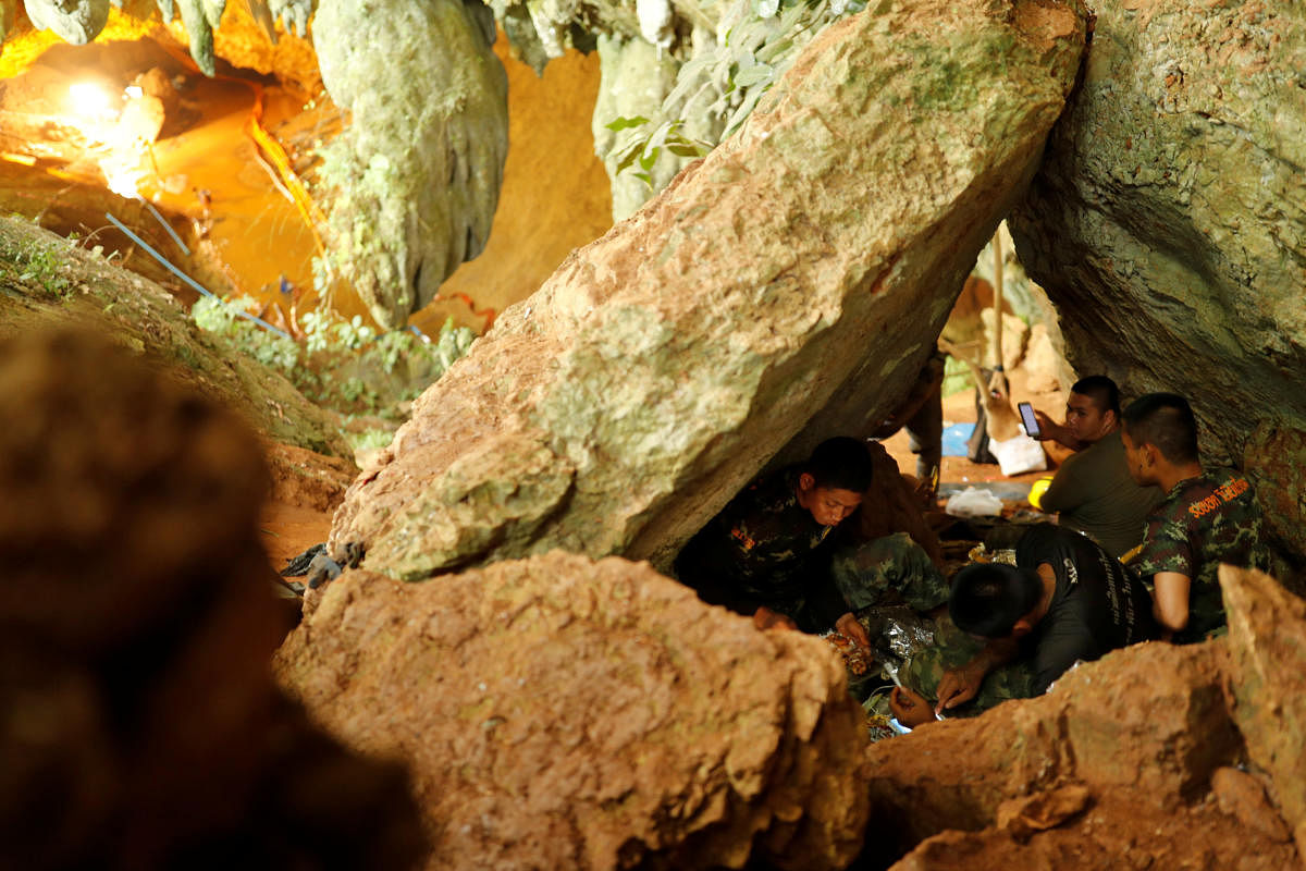 Rescue workers rest inside Tham Luang cave complex, where 12 schoolboys and their soccer coach are trapped inside a flooded cave, in the northern province of Chiang Rai, Thailand. (Reuters Photo)