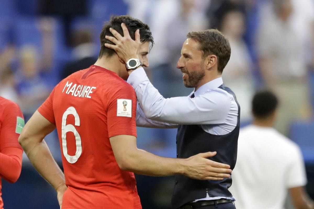 England head coach Gareth Southgate, right, celebrates the victory of his team over Sweden with England's Harry Maguire during the quarterfinal match. AP/PTI photo